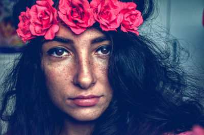 Close-up portrait of woman with pink roses