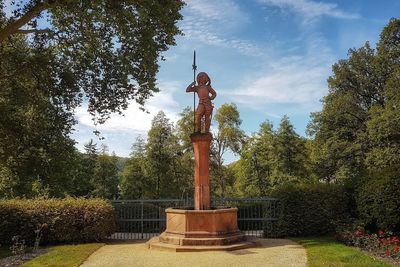 Statue against trees in park