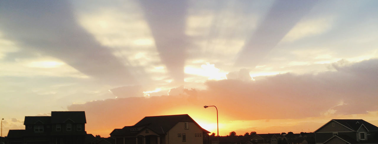 sky, architecture, building exterior, built structure, cloud, building, sunlight, sunset, dusk, evening, sun, city, house, residential district, nature, horizon, no people, silhouette, orange color, afterglow, outdoors, roof, dramatic sky, city life, beauty in nature