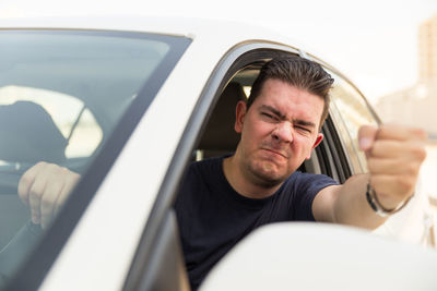 Close-up of man sitting in car