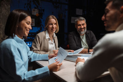 Business discussion in contemporary evening office of team