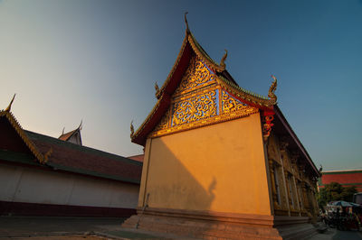 Low angle view of temple against building