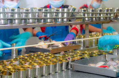 Canned fish factory. food industry. workers working in canned food factories to fill sardines 