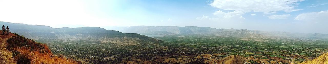 Scenic view of landscape against cloudy sky