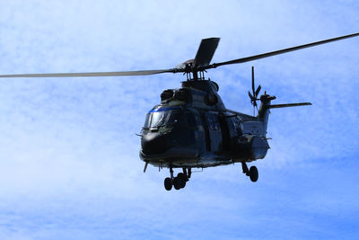 Low angle view of helicopter against sky