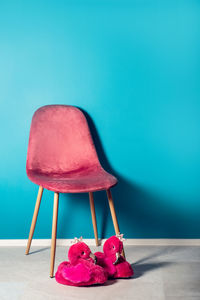 Close-up of empty chair on table against wall