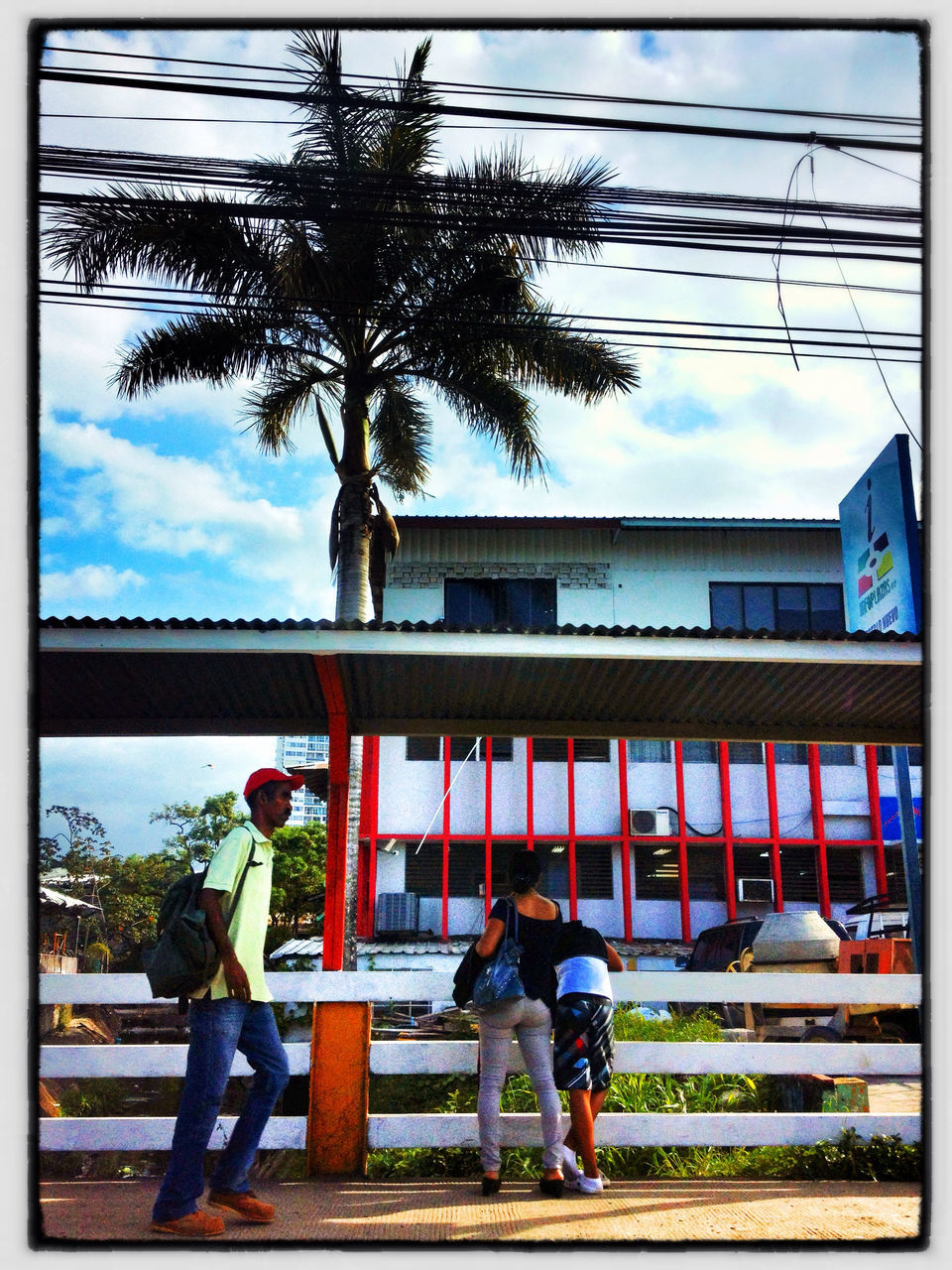 lifestyles, transfer print, architecture, built structure, full length, leisure activity, men, building exterior, sky, person, auto post production filter, tree, rear view, standing, casual clothing, togetherness, walking