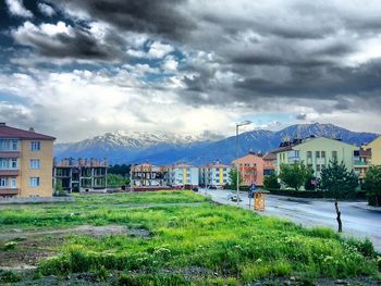 Houses against cloudy sky