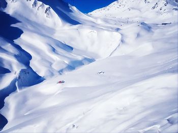 Scenic view of snow covered mountains against sky