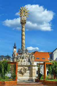 Low angle view of statue of historic building against sky