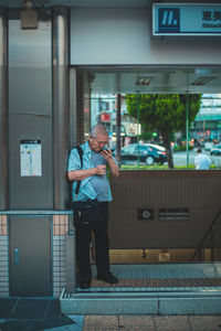 Man standing on mobile phone
