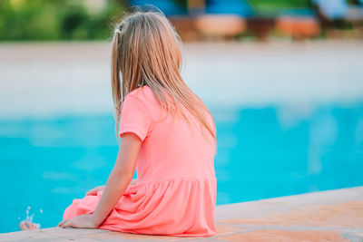 Woman sitting in swimming pool