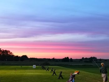 Scenic view of sunset over field