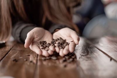 Low angle view of woman holding hands on table