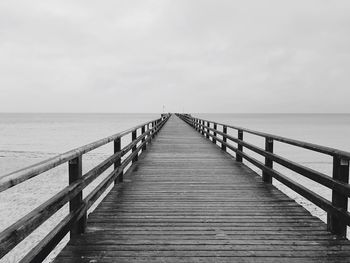 Pier over sea against sky