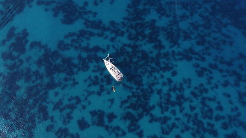 High angle view of sailing boat in a transparent sea