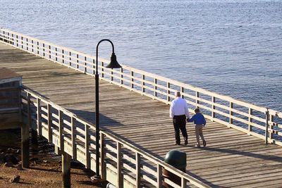 Rear view of a couple overlooking calm sea