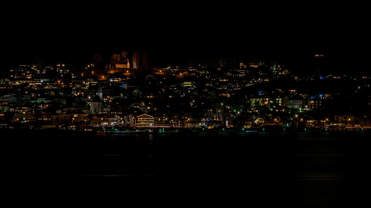 ILLUMINATED BUILDINGS AGAINST SKY AT NIGHT