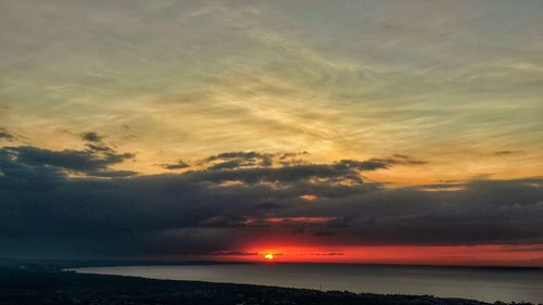 Scenic view of sea against romantic sky at sunset