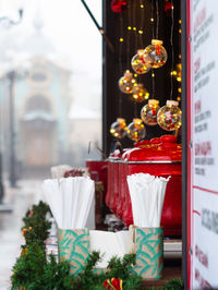 Christmas fair street food stall red pot mulled wine hot drink holiday market illuminated decoration