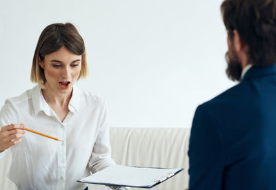 Female doctor examining patient in office