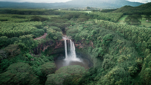 Scenic view of waterfall against sky