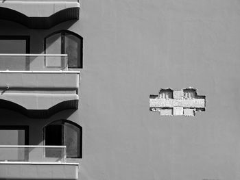 Close-up of chair on wall against building