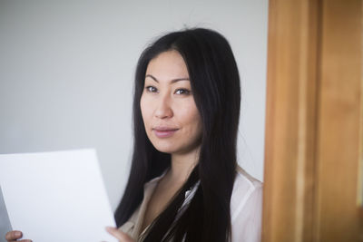 Young woman at home with paper