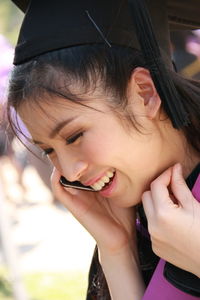Cheerful young woman talking on smart phone