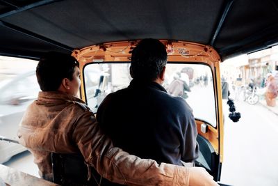 Rear view of man sitting in car