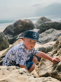 Boy on rock at beach