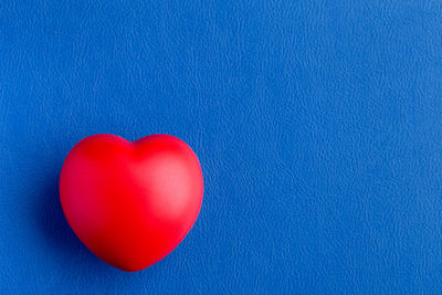 Directly above shot of heart shape over blue background