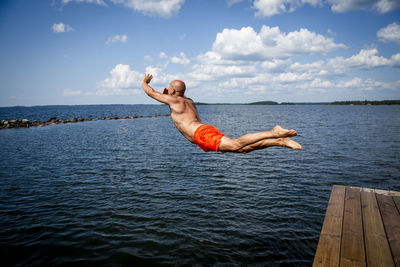Man jumping into sea