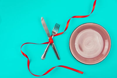 High angle view of red wine on blue table