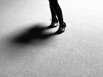 Low section of woman standing on tiled floor