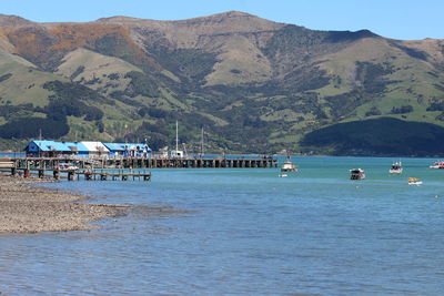 Scenic view of sea and mountains against sky