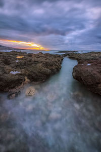 Long exposure image of sea against sky during sunset