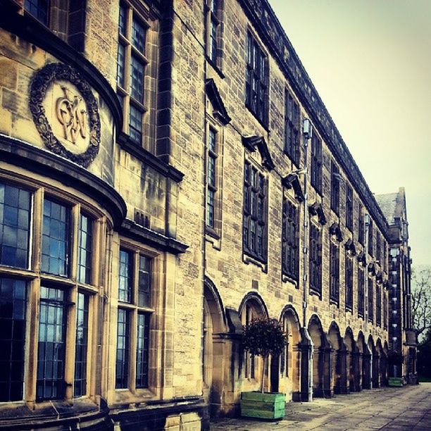 architecture, building exterior, built structure, window, building, low angle view, arch, facade, city, residential building, old, history, clear sky, day, outdoors, residential structure, sky, brick wall, no people, street