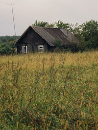 House on field against clear sky