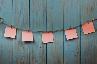 Close-up of clothes drying against blue wall