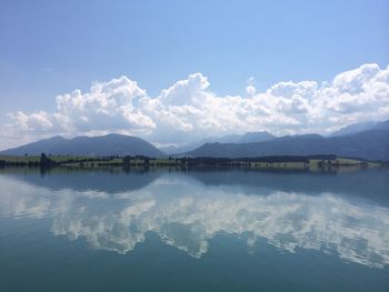 Scenic view of lake against cloudy sky