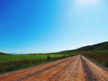 Country road against blue sky