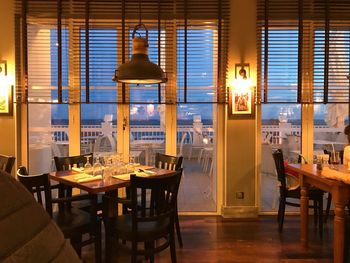 Empty chairs and tables in restaurant