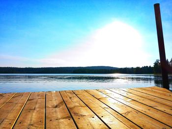 Pier over lake against blue sky