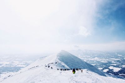 Hikers on snowcapped mountain