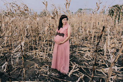 Portrait of woman standing on field