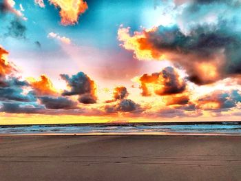 Scenic view of beach against sky during sunset