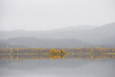 Scenic view of lake against sky during autumn