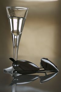 Close-up of drink with sunglasses on table