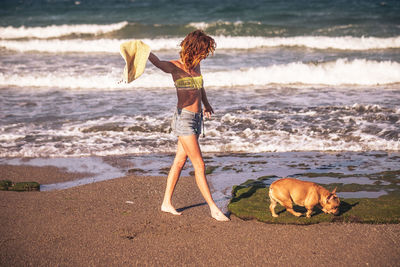 Woman with dog on beach